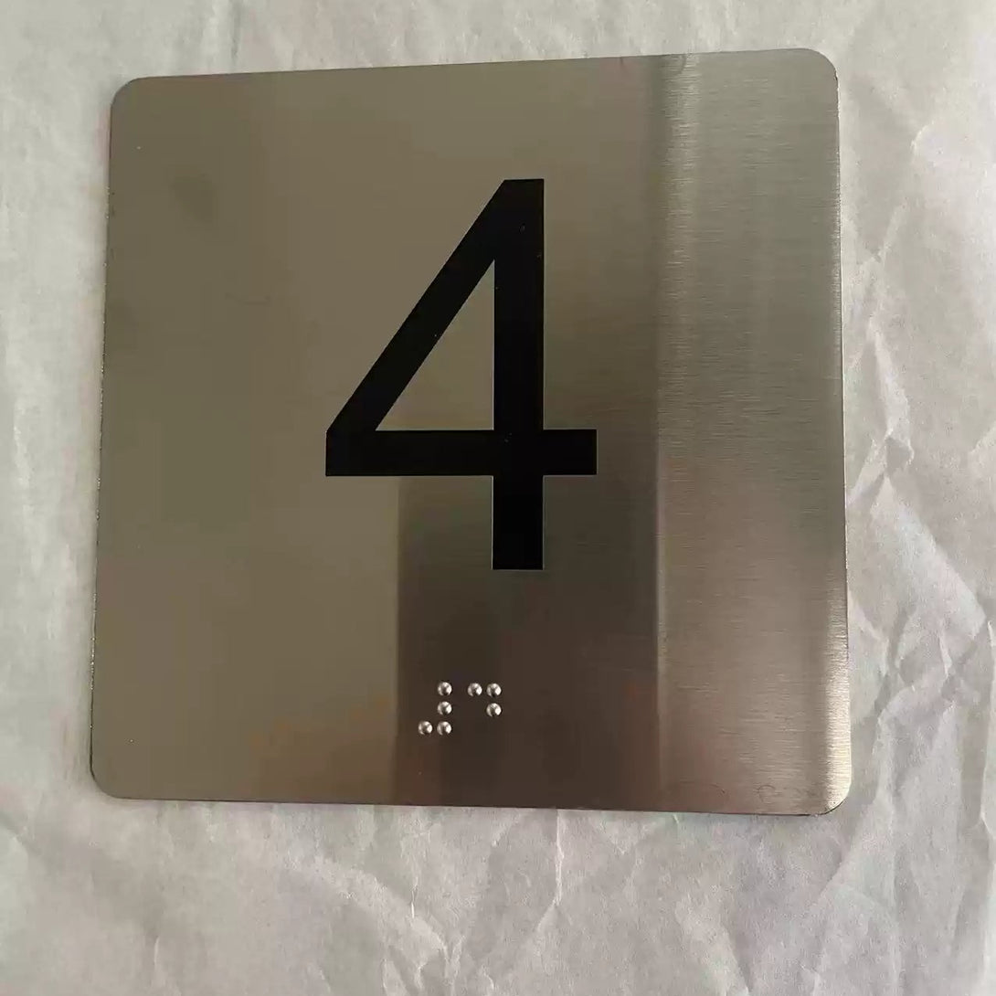 Metallic square with the number '4' on a textured white background
